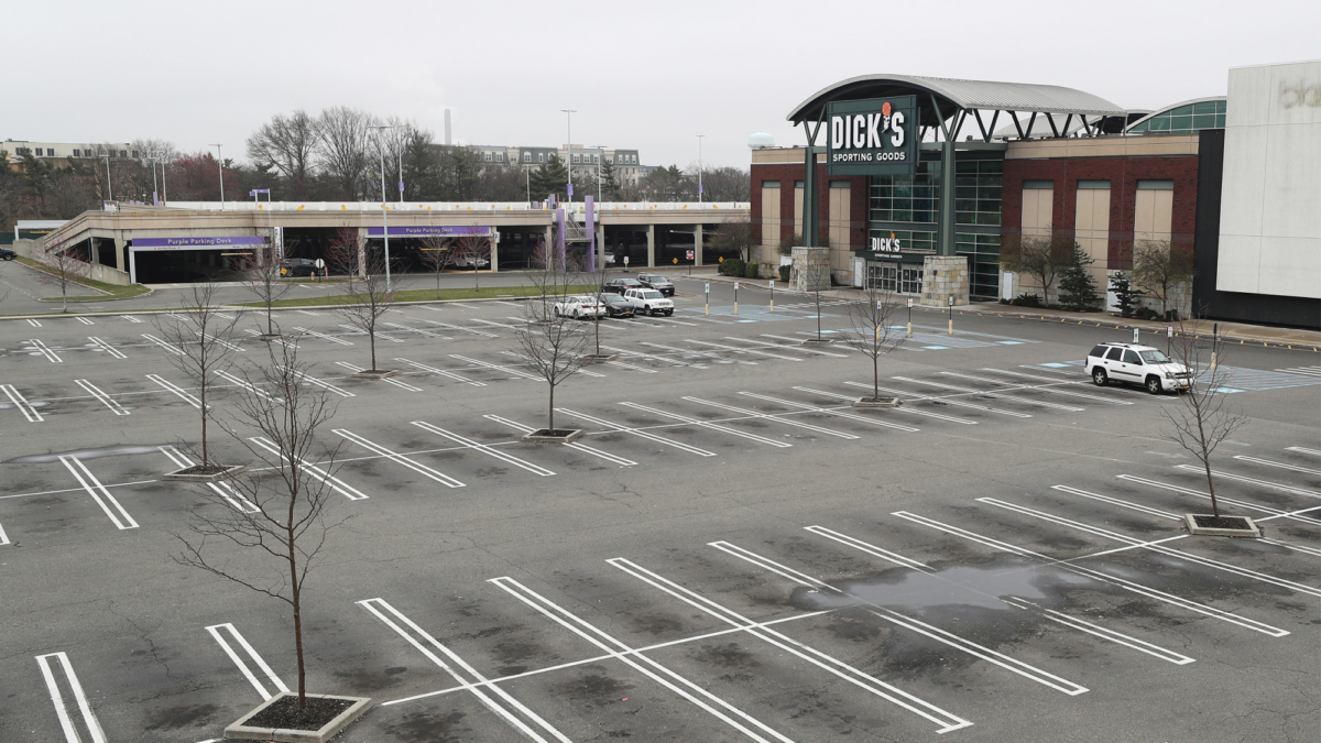 Dick's Sporting Goods store is shown with an empty parking lot amid the CCP virus pandemic at the Roosevelt Field Mall in East Garden City, New York, on March 20, 2020.