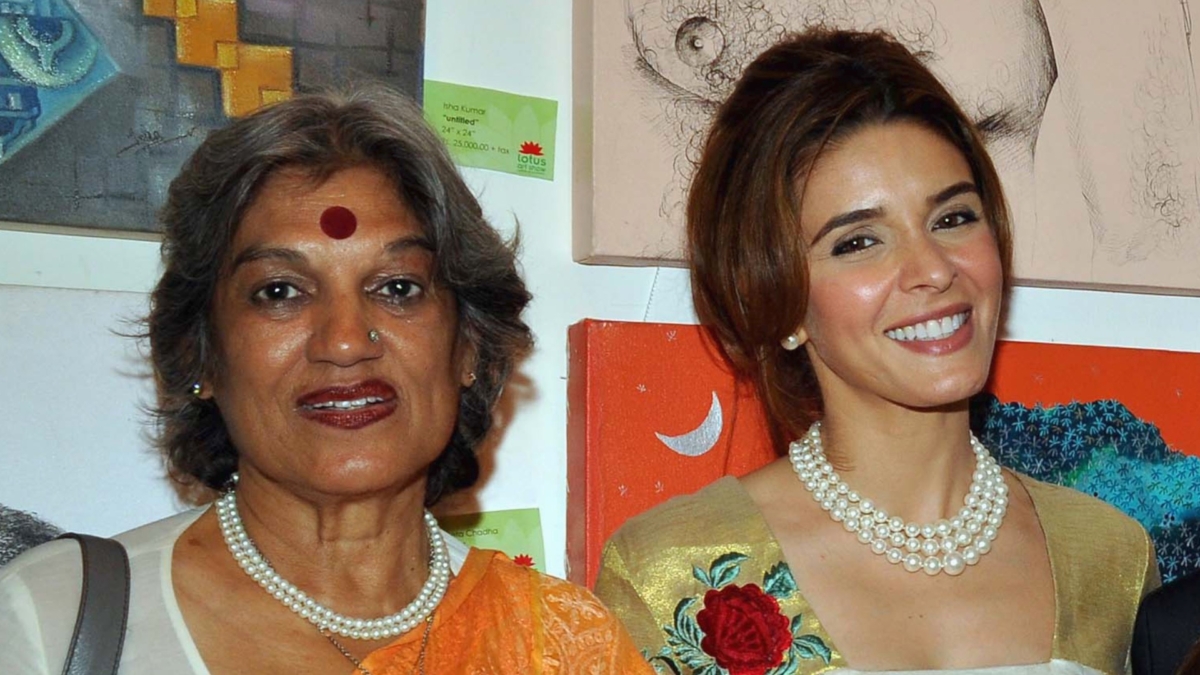 Indian actress Dolly Thakore, (L) and actress Raageshwari Loomba pose at the Lotus Art Show during International Women's Week in Mumbai on April 10, 2012. (STRDEL/AFP via Getty Images)