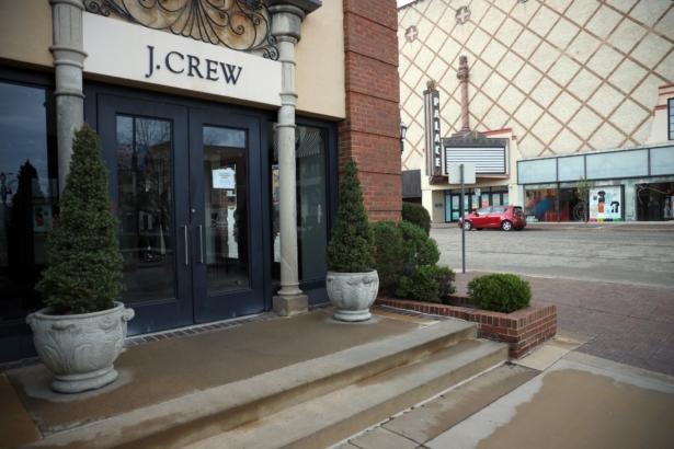 A closed sign is seen in the entrance of the J. Crew store at Country Club Plaza as the CCP virus Pandemic causes a climate of anxiety and changing routines in America in Kansas City, Mo., on April 2, 2020. (Jamie Squire/Getty Images)
