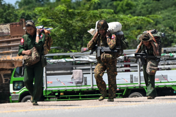 Burma soldiers walking along the Pyidaungsu highway road outside Kutkai in Shan State, on Aug. 25, 2019. (Ye Aung Thu/AFP via Getty Images)