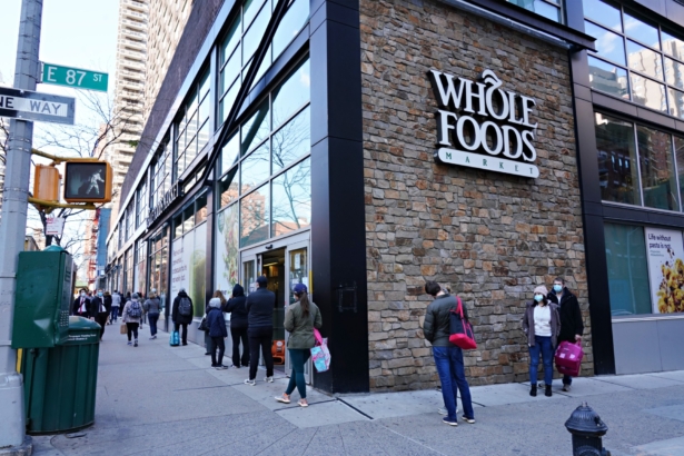 People line up in front of Whole Foods during the COVID-19 pandemic in New York City, N.Y., on April 15, 2020. (Cindy Ord/Getty Images)