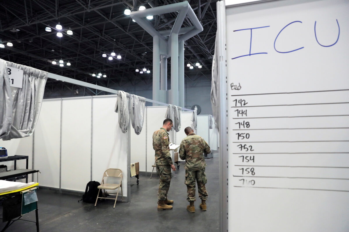 U.S. Army Medical Personnel from the 531st Hospital Center out of Fort Campbell, Kentucky, and the 9th Hospital Center out of Fort Hood, Texas, walk amongst cubicles in phase 2 of the Javits New York Medical Station at the Jacob K. Javits Convention Center during the COVID-19 outbreak in Manhattan, New York City, on April 3, 2020. (Andrew Kelly/Reuters)