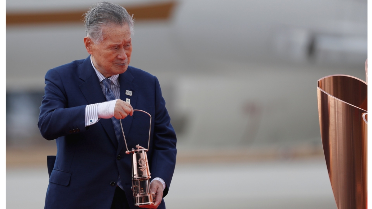 Tokyo 2020 Olympics President Yoshiro Mori holds the Olympic Flame during a ceremony at Japan Air Self-Defense Force Matsushima Base in Higashi-Matsuhsima, Miyagi prefecture, northern Japan on March 20, 2020. (Issei Kato/File Photo/Reuters)