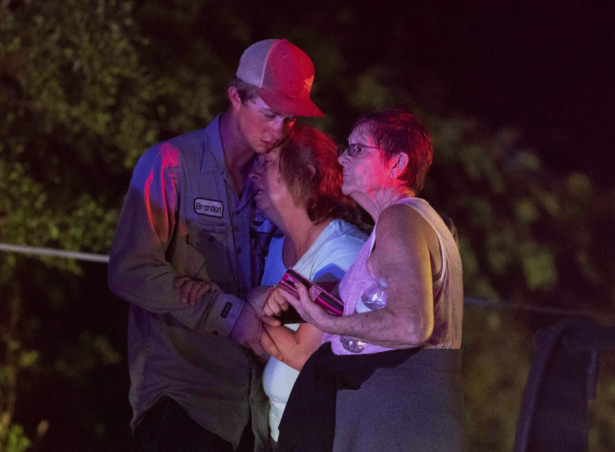 People embrace after an apparent tornado touched down in Onalaska, Texas on April 22, 2020. (Jason Fochtman/Houston Chronicle via AP)