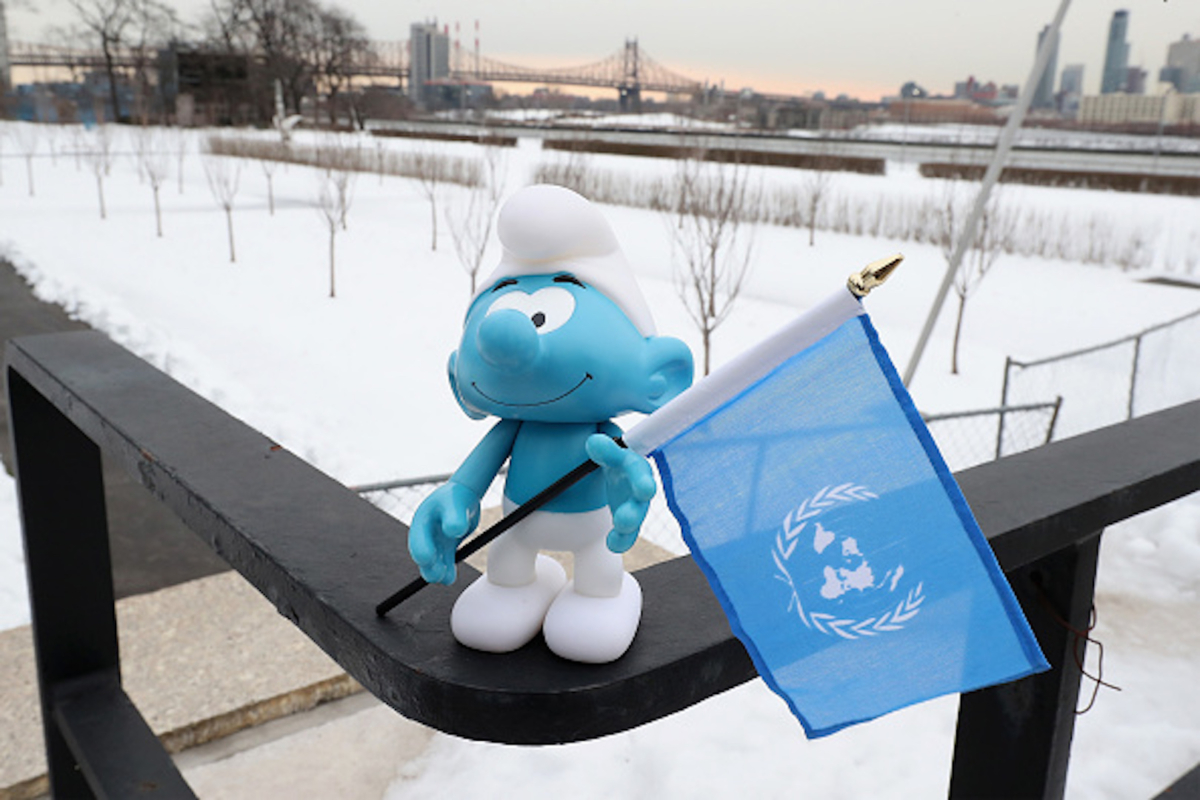 A Smuf holding a UN flag at the United Nations Headquarters celebrating International Day of Happiness in conjunction with SMURFS: THE LOST VILLAGE in New York City on March 18, 2017. (Cindy Ord/Getty Images for Sony Pictures)