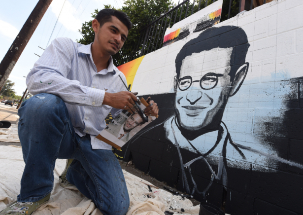 Artist Levi Ponce poses with his Memorial Day mural project of murdered journalist Daniel Pearl, near his old neighborhood in Los Angeles, Calif., on May 23, 2015. (Mark Ralston/AFP via Getty Images)