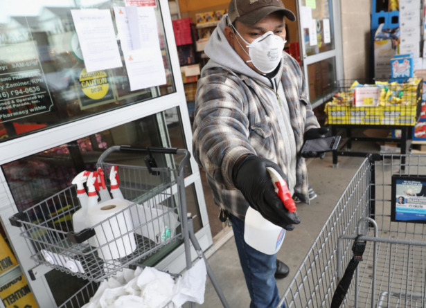 A worker at the ShopRite supermarket disinfects shoppers carts prior to allowing customers into the store in Plainview, N.Y., on April 03, 2020. (Bruce Bennett/Getty Images)