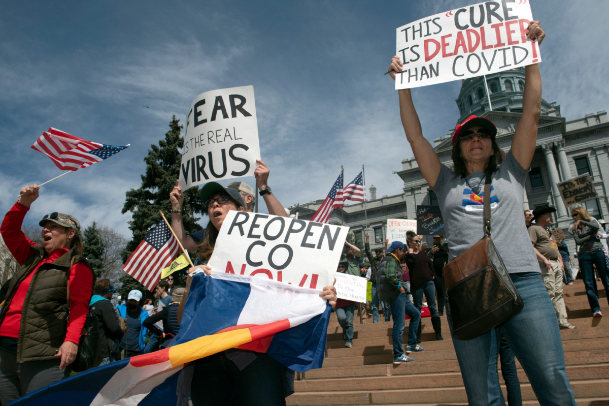 Demonstrators gather in front of the Colorado State Capitol building to protest CCP virus stay-at-home orders during a "ReOpen Colorado" rally in Denver, Colo, on April 19, 2020. (Photo bJason Connolly/AFP via Getty Images)