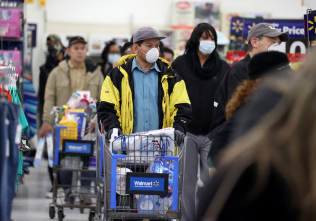 People wearing masks and gloves wait to checkout at Walmart in Uniondale, New York City on April 3, 2020. (Al Bello/Getty Images)