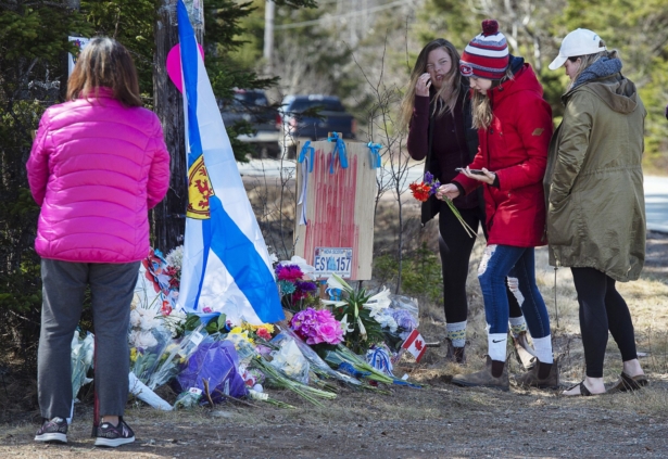 Following a shooting rampage on April 18, people pay their respects at a memorial in Portapique, Nova Scotia, Canada, on April 22, 2020. (Andrew Vaughan/The Canadian Press via AP)