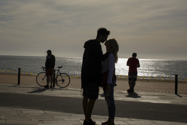 A couple kiss in front of the sea in Barcelona, Spain on May 2, 2020. (Emilio Morenatti/AP Photo)