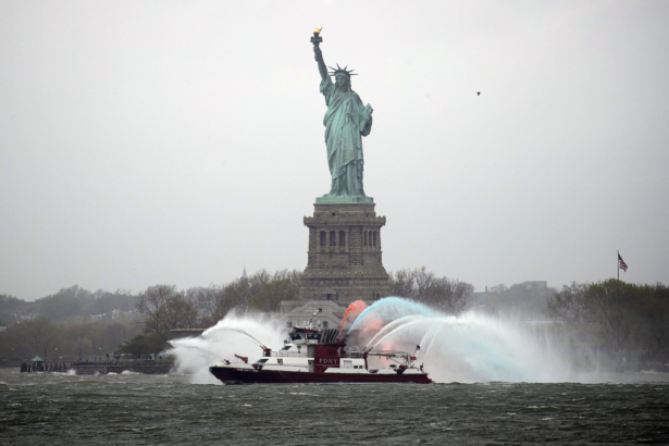 Three-Forty-Three fireboat escorts the USNS Comfort hospital ship (not pictured) out of the harbor as it heads back to Naval Station Norfolk, Va., on April 30, 2020. (Justin Heiman/Getty Images)