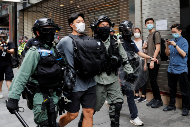 Riot police officers detain a demonstrator during a protest against the second reading of a controversial national anthem law in Hong Kong, China, on May 27, 2020. (Tyrone Siu/Reuters)