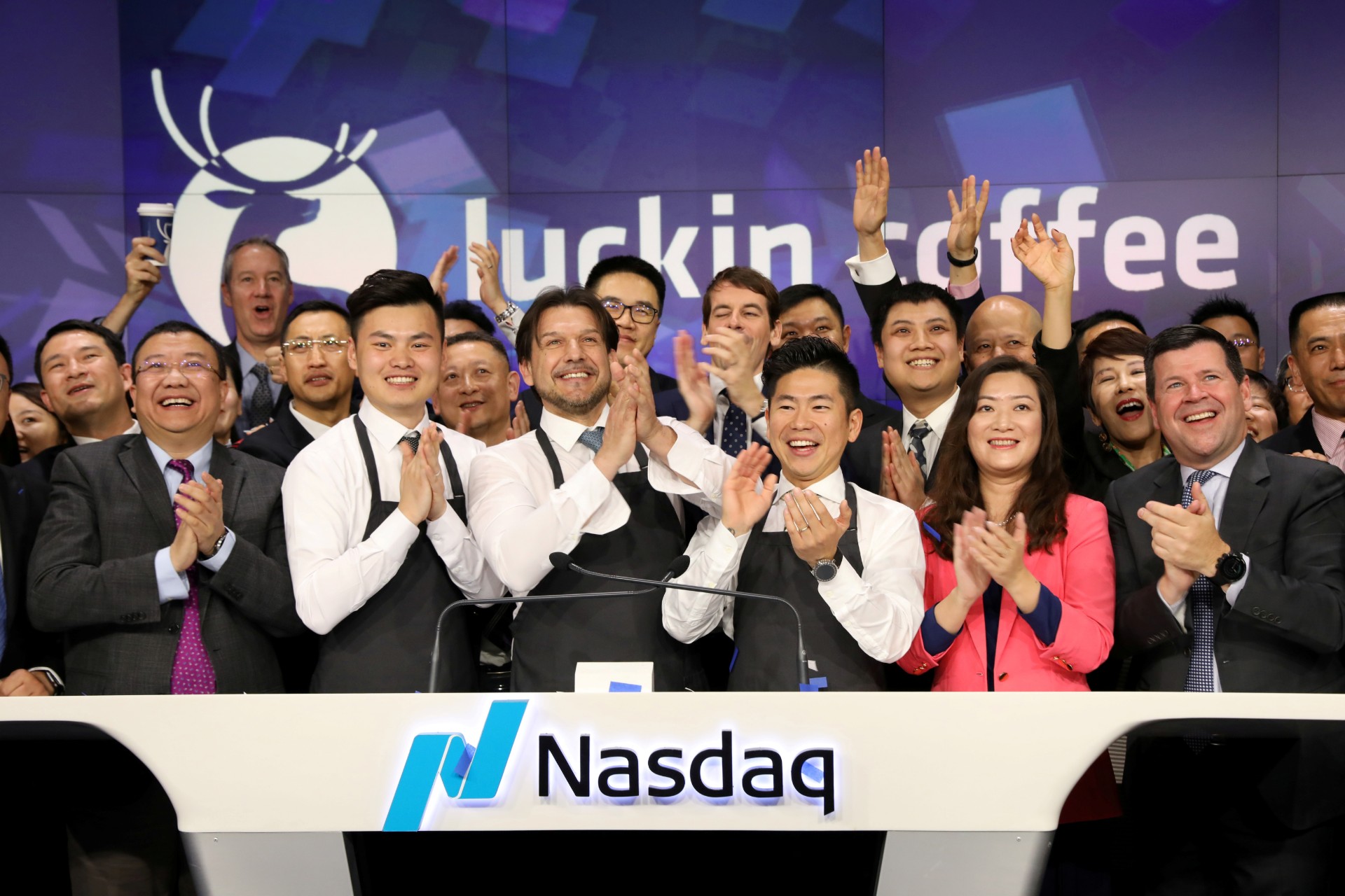 Jenny Qian Zhiya CEO of Luckin Coffee, and Charles Zhengyao Lu, non-executive chairman of Luckin Coffee, ring the Nasdaq opening bell with employees to celebrate the company's IPO at the Nasdaq Market site in New York, on May 17, 2019. (Brendan McDermid/File Photo/Reuters)