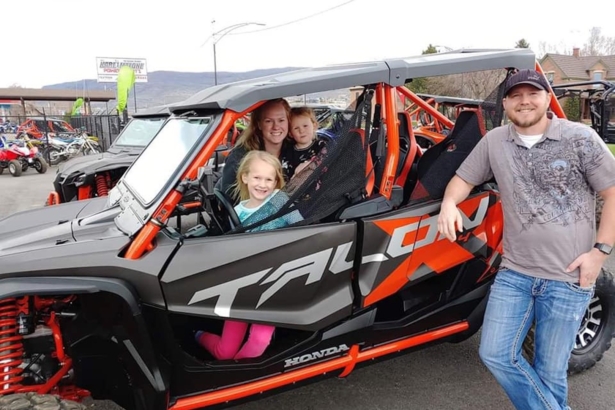 The family from Salt Lake City with Tim (R) and Kinzley, Ellie and Becky sitting inside vehicle. (GoFundMe)