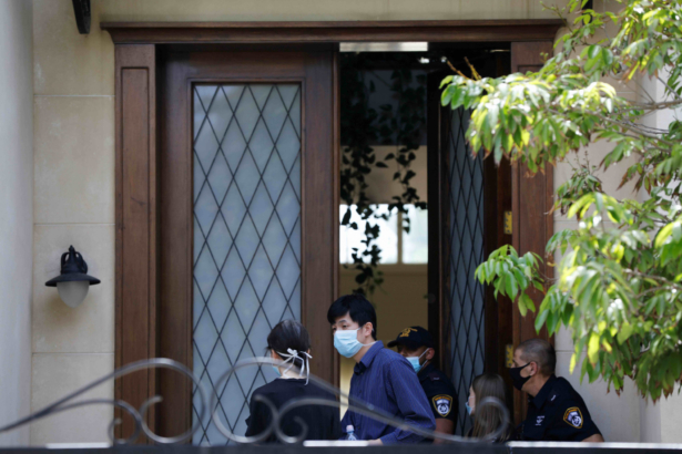 People and Israeli police are seen at the door of China's ambassador to Israel, Du Wei's home in Herzliya, near Tel Aviv, Israel May 17, 2020. (Nir Elias/Reuters)