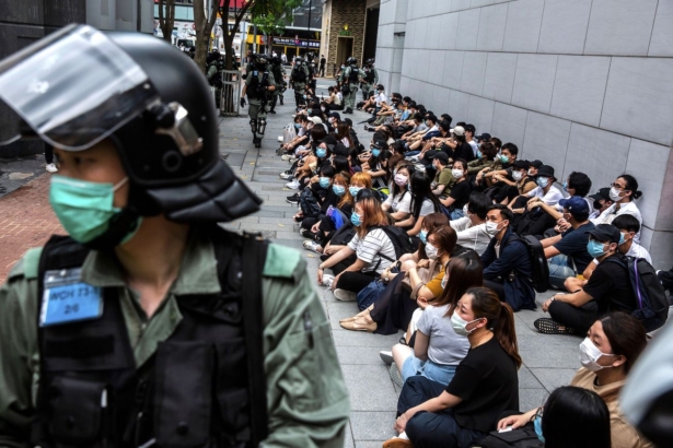 Riot police detain a group of people during a protest in the Causeway Bay district of Hong Kong as the city's legislature debates over a law that bans insulting China's national anthem on May 27, 2020. (Isaac Lawrence/AFP/Getty Images)