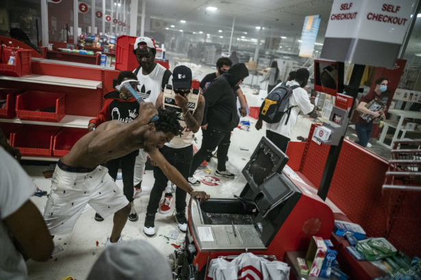 A looter uses a claw hammer