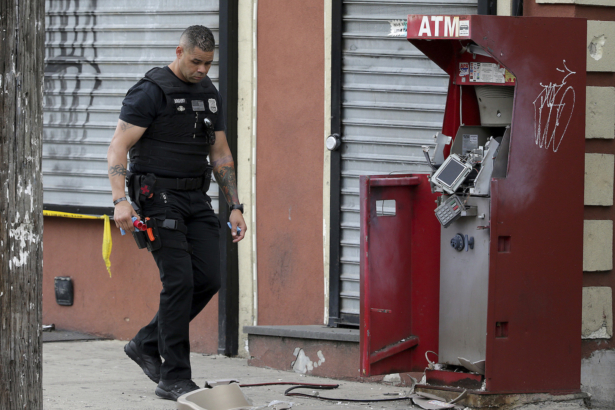 A member of the Philadelphia bomb squad surveys the scene after an ATM machine was blown-up at 2207 N. 2nd Street in Philadelphia, Pa. on June 2, 2020. (David Maialetti/The Philadelphia Inquirer/AP)