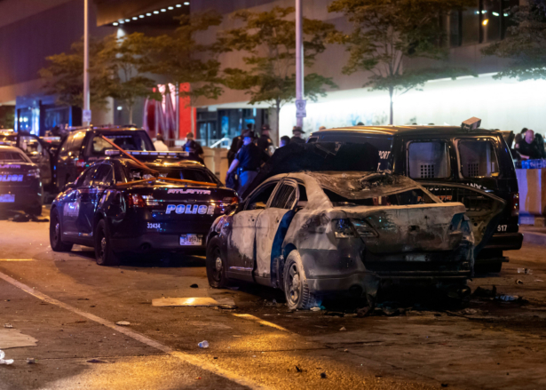 A burned out car sits idle during rioting and protests in Atlanta on May 29, 2020. (John Amis/AFP via Getty Images)