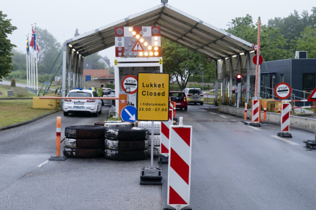 A sign with the opening hours of the border checkpoint between Harrislee in Germany and Padborg in Denmark is displayed in front the border crossing in Harrislee, Germany, on June 13, 2020. (Frank Molter/dpa via AP)