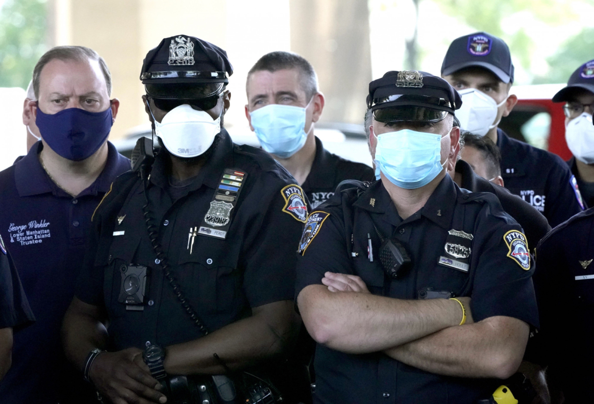 NYPD Police officers listen as Police Benevolent Association of the City of New York President Pat Lynch and representatives from other NYPD and law enforcement unions holds a news conference at the Icahn Stadium parking lot to address the "current anti-law enforcement environment" in New York City on June 9, 2020. (Timothy A. Clary/AFP via Getty Images)