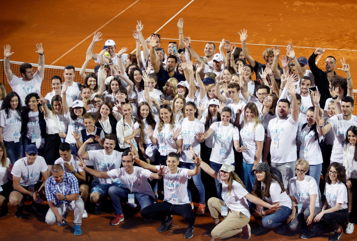 Serbia's Novak Djokovic (C) poses with volunteers and players after the Adria Tour charity tournament in Belgrade, Serbia, on June 14, 2020. (Darko Vojinovic/AP Photo)