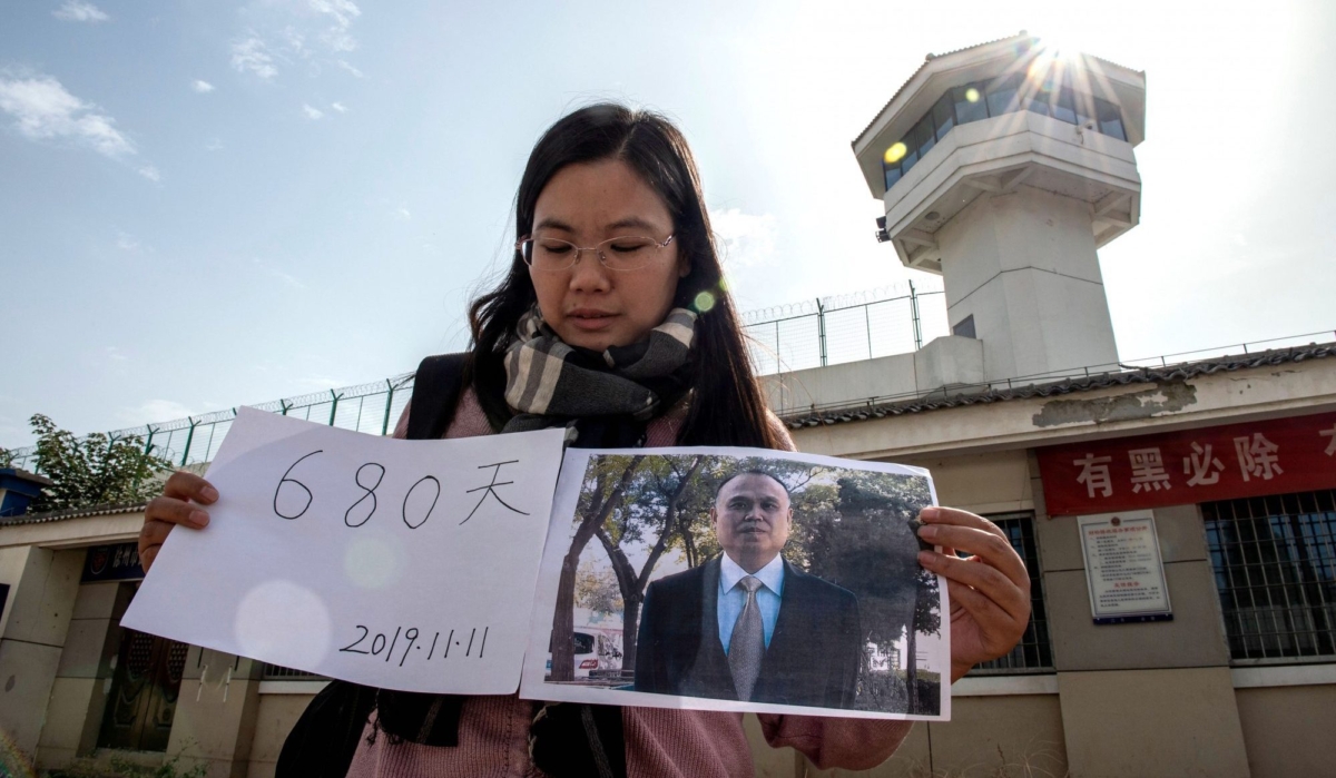 Xu Yan, wife of human rights lawyer Yu Wensheng, makes a video for her husband's birthday, filmed in front of the Xuzhou City Detention Centre, on Oct. 30, 2019. The date on the paper marks 680 days under detention. (Nicholas Asfouri/AFP/Getty Images)