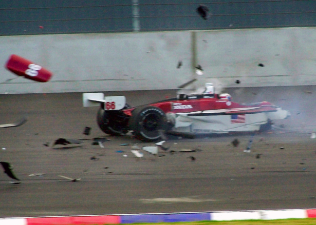 Italian driver Alex Zanardi sitting in his car as it breaks up around him after a crash with Canadian driver Alex Tagliani during the CART car race at the Eurospeedway Lausitz in Klettwitz, eastern Germany, on Sept. 15, 2001. (Eckehard Schulz/AP/File)
