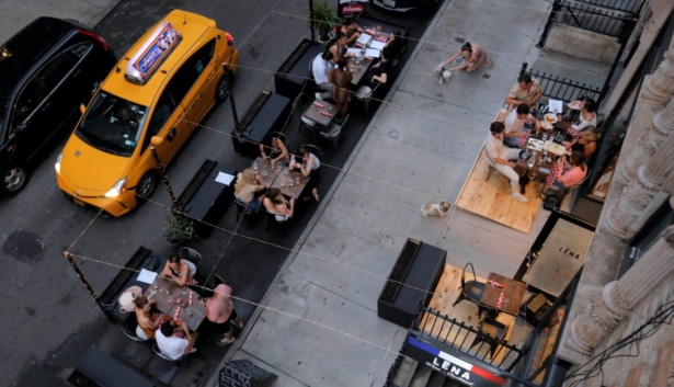 People eat outside of LENA Winebar as restaurants are permitted to offer al fresco dining as part of phase 2 reopening during COVID-19 outbreak in the Lower East Side neighborhood of Manhattan in New York City, N.Y., on June 27, 2020. (Andrew Kelly/Reuters)