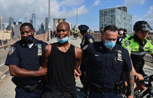 People get arrested on the Brooklyn Bridge after about a dozen Black Lives Matter protesters briefly shut down the bridge on July 15, 2020 in New York City. (Angela Weiss/AFP via Getty Images)