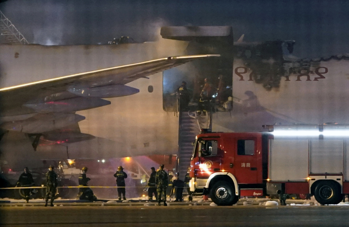 Firefighters work at the site where an Ethiopian Airlines cargo plane caught fire, at Shanghai Pudong International Airport in Shanghai, China, on July 22, 2020. (Aly Song/Reuters)