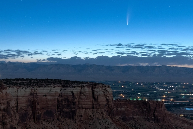 Comet Neowise soars in the horizon of the early morning sky in this view from the near the grand view lookout at the Colorado National Monument west of Grand Junction, Colo., on July 9, 2020. (Conrad Earnest via AP)