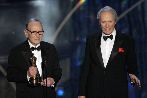 Italian composer Ennio Morricone (L) accepts an honorary Oscar for his contributions to the art of film music as director Clint Eastwood looks on during the 79th Academy Awards telecast in Los Angeles, on Feb. 25, 2007. (Mark J. Terrill/file/AP Photo)