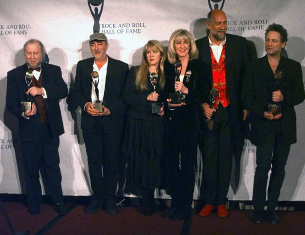 Members of Fleetwood Mac hold their awards after the group was inducted into the Rock and Roll Hall of Fame, in New York on Jan. 12, 1998. (Adam Nadel/AP Photo)