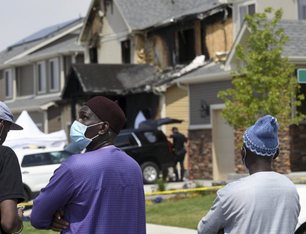 Amadou Deh stands in front of the remnants of a house fire that killed five people in suburban Denver on Aug. 5, 2020. (Thomas Peipert/AP Photo)