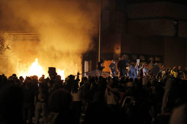 Protesters gather in front of the burning 3rd Precinct of the Minneapolis Police Department in Minn., on May 28, 2020. (Julio Cortez/AP Photo)