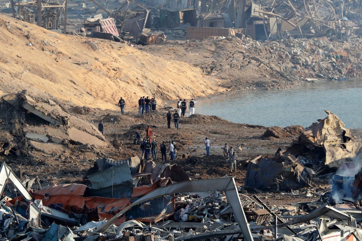 Police and forensic officers work at the scene of an explosion which took place yesterday at the port of Lebanon's capital Beirut, on Aug. 5, 2020. (Anwar Amro/AFP via Getty Images)