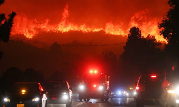 Flames from the Lake Fire burn on a hillside near a fire truck and other vehicles in Lake Hughes, Calif., on Aug. 12, 2020. (Mario Tama/Getty Images)