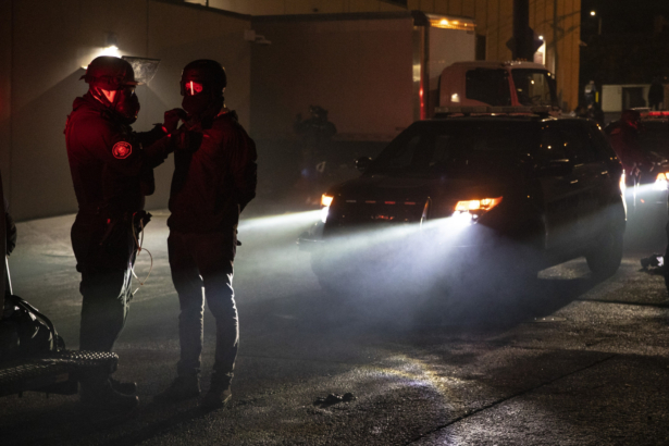 Police arrest a person during the dispersal of an unlawful assembly at the Immigration and Customs Enforcement detention center in Portland, Ore., on Sept. 18, 2020. (Paula Bronstein/AP Photo)