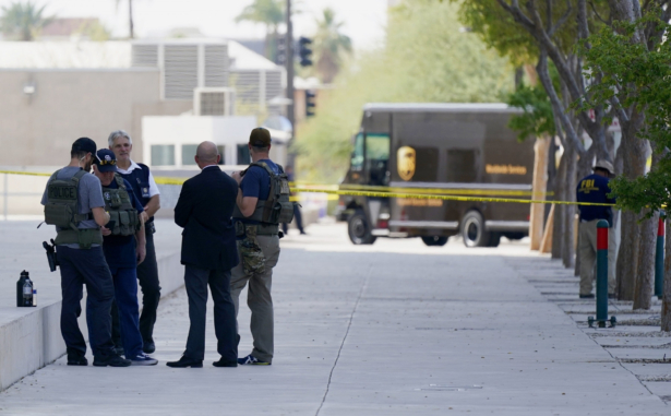 Federal law enforcement personnel stand outside the Sandra Day O'Connor Federal Courthouse, in Phoenix, Sept. 15, 2020. (AP Photo/Ross D. Franklin)