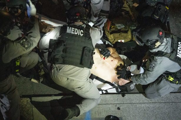 A man shot in Portland, Ore., is treated on Aug. 29, 2020. The man later died. (Nathan Howard/Getty Images)