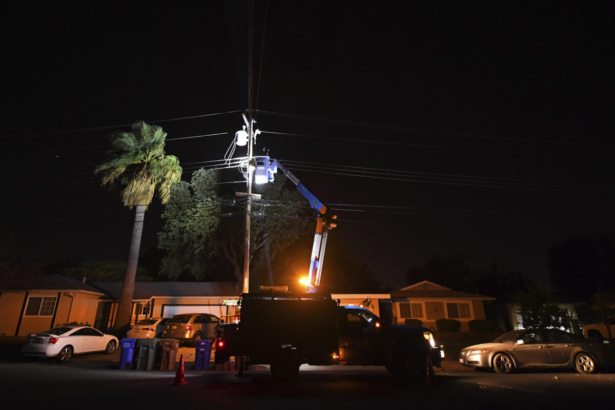 A PG&E lineman works on repairing electrical wires that were touching due to high winds on Manzanita Court in Concord, Calif., on Oct. 25, 2020. (Jose Carlos Fajardo/Bay Area News Group via AP)