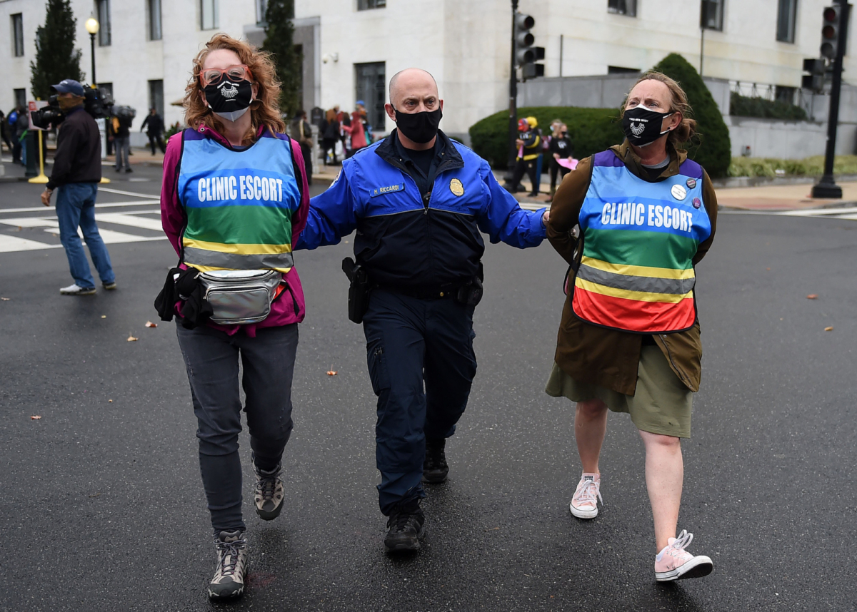 Protesters get arrested by U.S. Capitol police after blocking the entrance of Hart Senate building on the first day of the nomination hearing for President Donald Trump's Supreme Court nominee, Amy Coney Barrett, in Washington on Oct. 12, 2020. (Olivier Douliery/AFP via Getty Images)