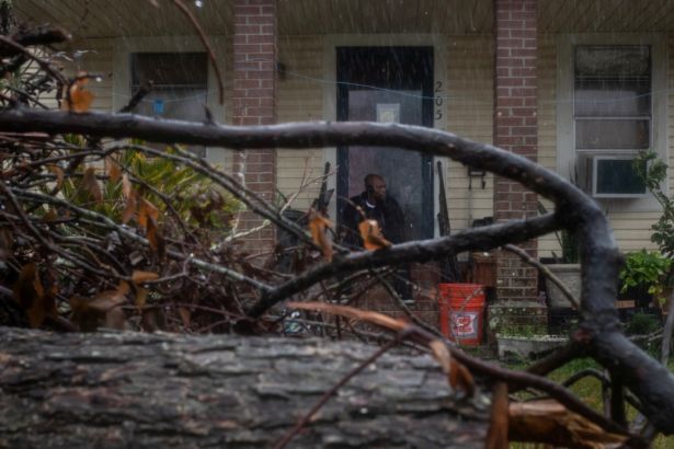 Michael Roberson, 46, is framed by debris from Hurricane Laura, as he watches the arrival of Hurricane Delta from his doorsteps in Lake Charles, Louisiana, U.S., October 9, 2020. (Adrees Latif/Reuters)