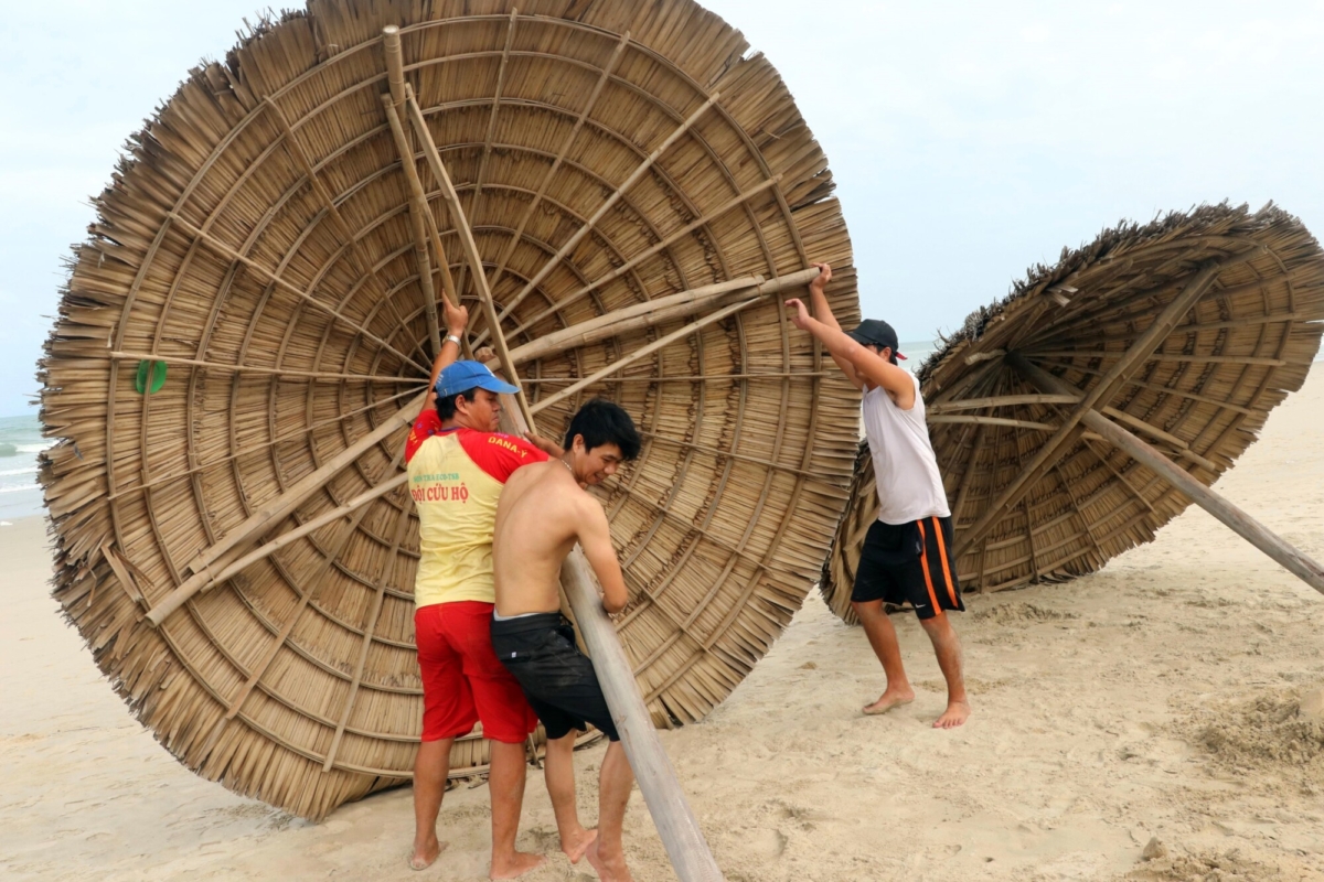 People remove beach cabanas ahead of Typhoon Molave in Danang, Vietnam, on Oct. 26, 2020. . (Tran Le Lam/VNA via AP)