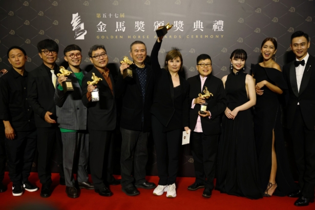 Director Chen Yu-hsun and others pose with the Best Narrative Feature award for "My Missing Valentine" at the 57th Golden Horse Awards in Taipei, Taiwan, on Nov. 21, 2020. (Ann Wang/Reuters)