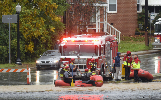 Charlotte Fire water rescue stand at the ready on West Blvd. during a heavy rain in Charlotte, N.C., on Nov. 12, 2020. (Jeff Siner/The Charlotte Observer via AP)