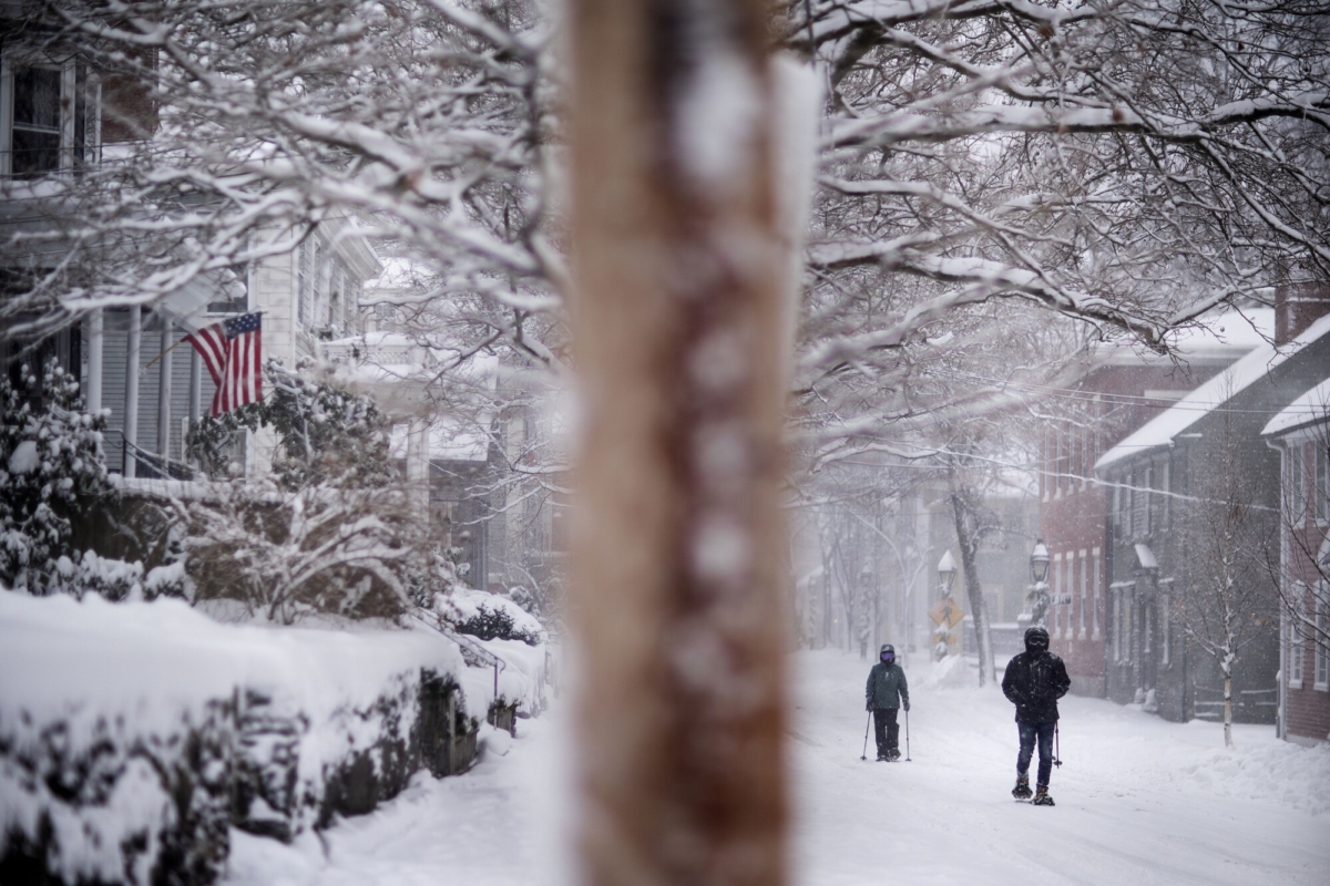 A couple uses snowshoes to walk down Benefit Street during a snowstorm in Providence, R.I., on Dec. 17, 2020. (David Goldman/AP Photo)