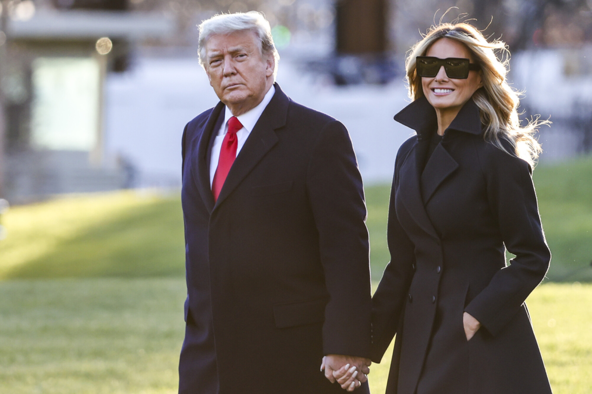 President Donald Trump and first lady Melania Trump walk on the south lawn of the White House in Washington on Dec. 23, 2020. (Tasos Katopodis/Getty Images)